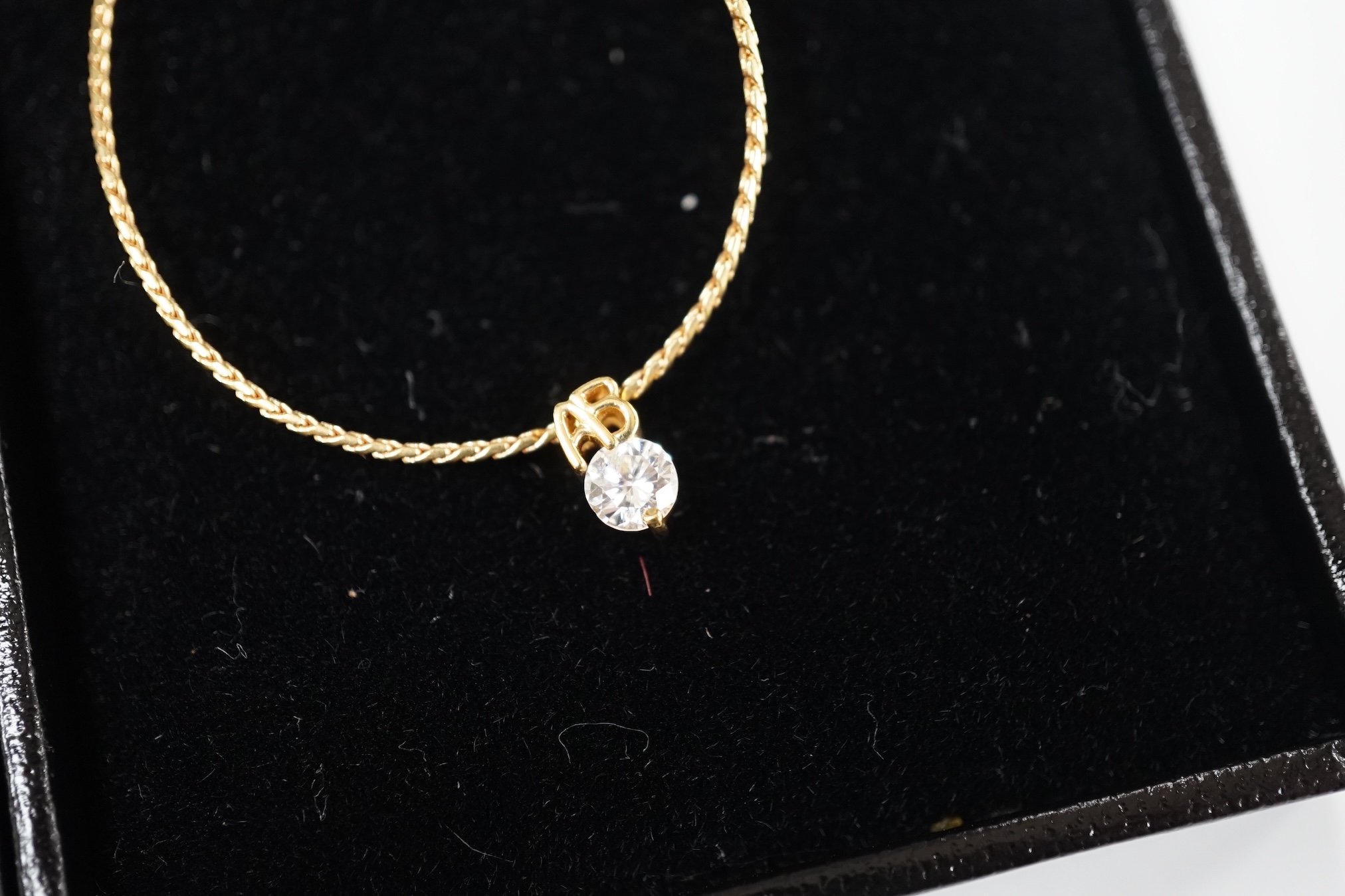 A modern 18k and solitaire diamond set necklet, 36cm, together wit a modern Italian Uno-A-Erre 18k, cabochon sapphire and diamond set necklet, 46cm, gross weight 7 grams. Condition - good